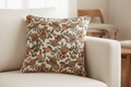 Housse de coussin en tapisserie motifs grenades et citrons sur canapé.