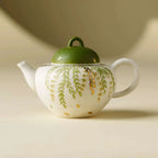 Théière artisanale en céramique 120ml avec motifs de feuilles vertes.