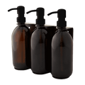 Triple distributeur de savon mural avec flacons verre ambré et pompe noire.