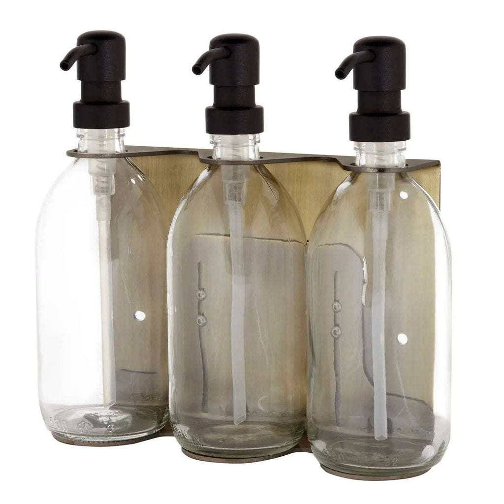 Triple distributeur de savon mural avec flacons verre transparent et pompe noire.