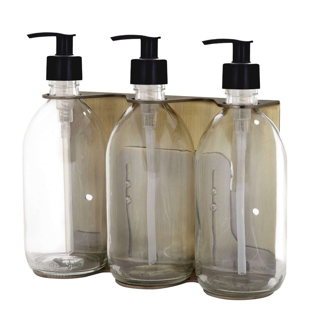 Triple distributeur de savon mural avec flacons verre ambré et pompe plastique noire.